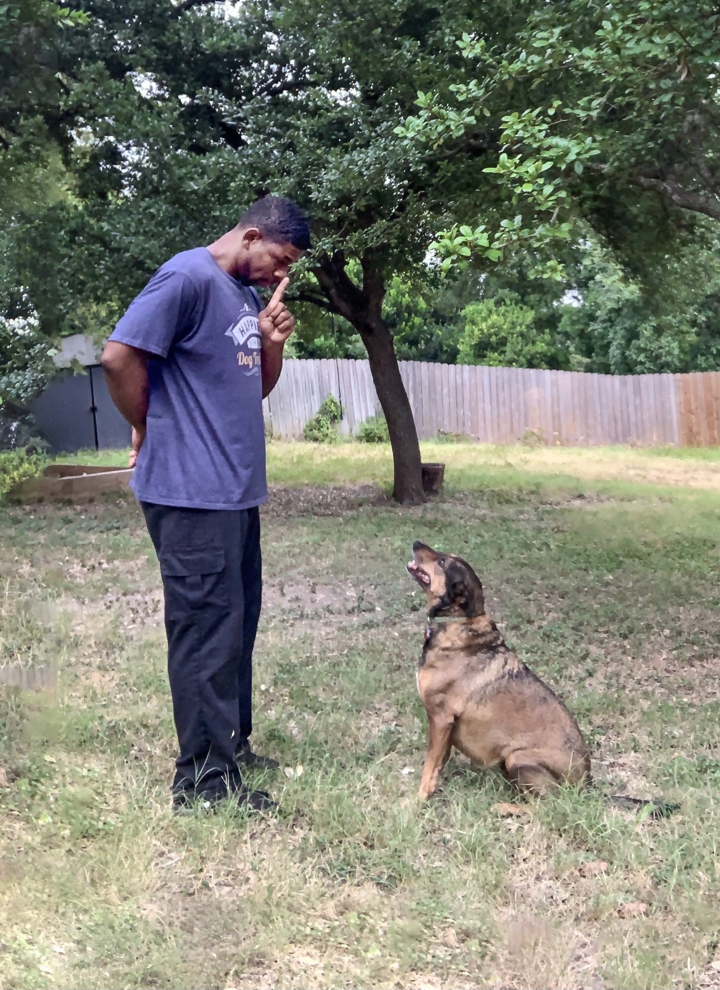 Jamaal rewarding eye contact with a dog during outdoor training