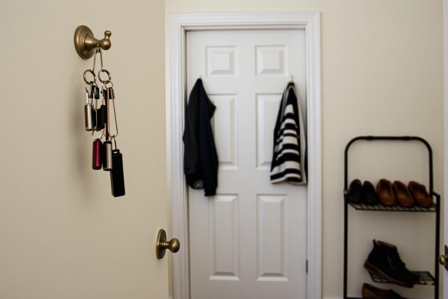 Front door of a home viewed from inside a tidy entryway with a dog bed nearby